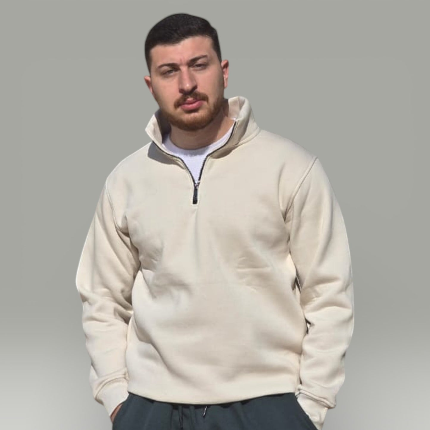 AnyWear unisex cream quarter-zip pullover sweatshirt with a stand-up collar worn by a man against a grey background