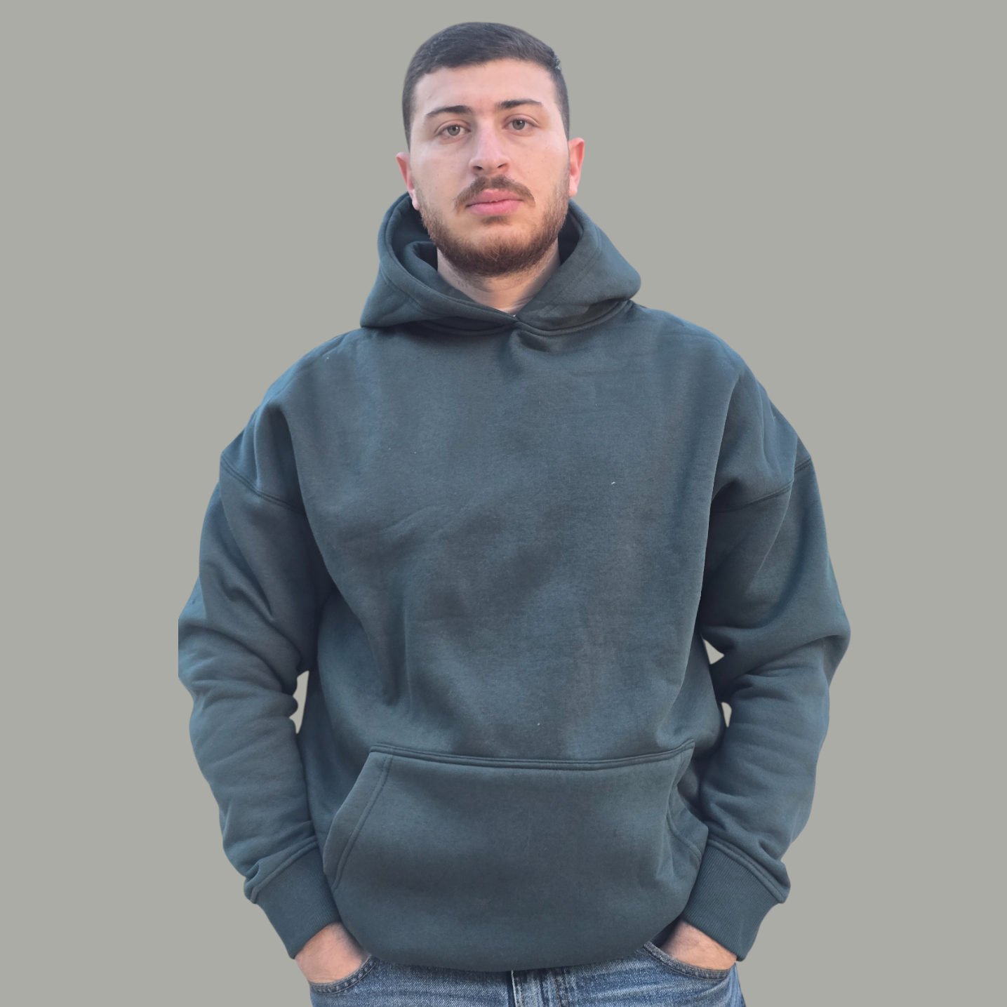 Man wearing a green hoodie against a plain background