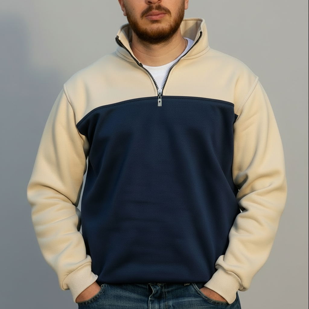 Person wearing a two-tone fleece pullover with beige and navy sections on a gray background