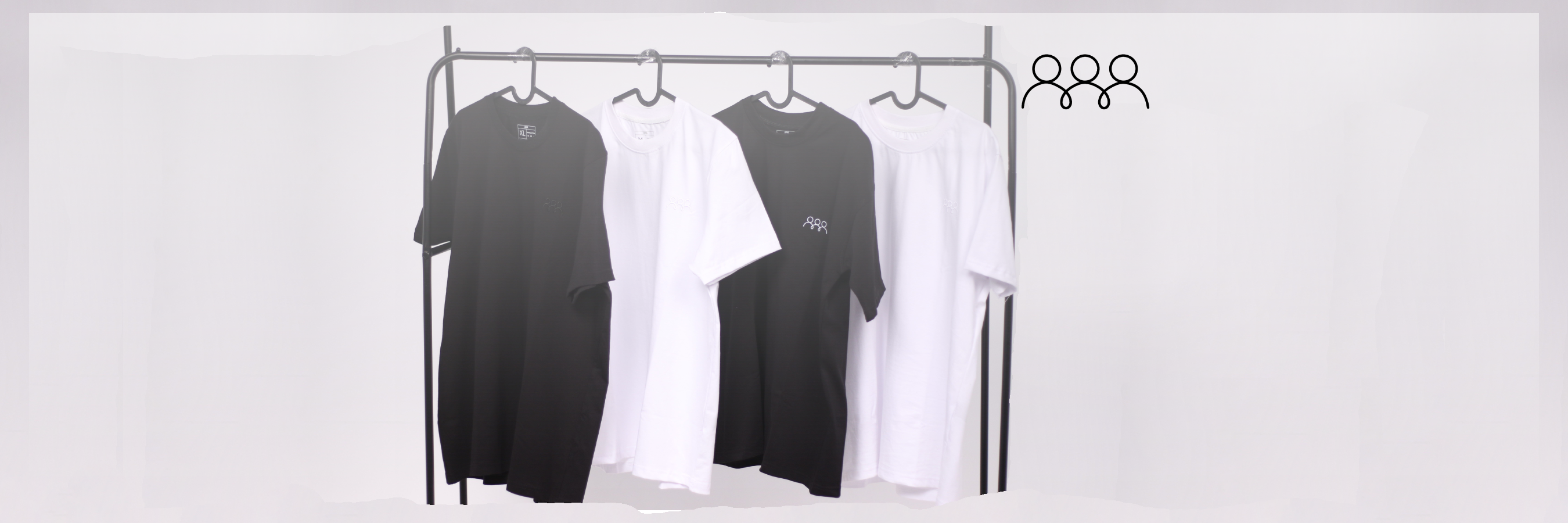 Black and white t-shirts on a clothing rack against a light gray background