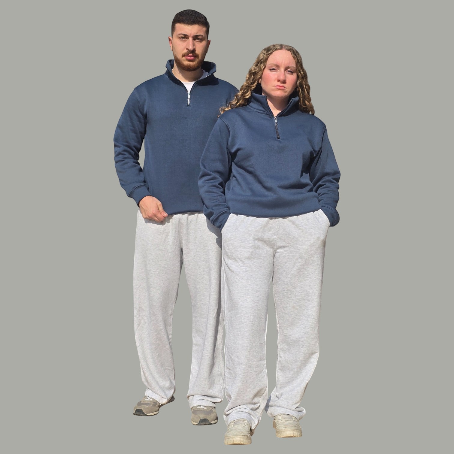 AnyWear unisex navy blue quarter zip pullover sweatshirt worn by a man and woman with grey sweatpants